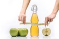 Composition with green apples, a bottle of apple juice and a tailor meter in hands isolated on a white background with space for Royalty Free Stock Photo