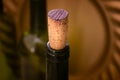 Close-up of wine bottle neck with cork against warm blurred background Royalty Free Stock Photo