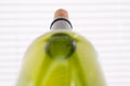 Close-up of green wine bottle with cork against bright striped background Royalty Free Stock Photo