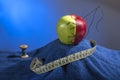 composition: green-red apple with the needle and thread on a blue towel. Near it blue coil of thread and centimeter for sewing Royalty Free Stock Photo