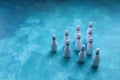 Group of white bowling pins on a blue background. Selective focus. Royalty Free Stock Photo
