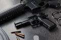 Composition with gun and bullets on stone table Royalty Free Stock Photo