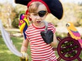 Composition of happy children's day text and caucasian boy in party pirate costume