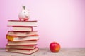 Composition with hardback books, fanned pages on wooden deck table and pink background. Books stacking. Back to school. Copy Space Royalty Free Stock Photo