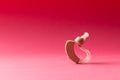 Composition of hearing aid on red background with copy space Royalty Free Stock Photo