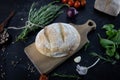 Composition with homemade breads on a wooden board, on a black background Royalty Free Stock Photo