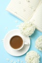 Composition hydrangea flowers and coffee on blue background