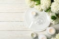 Composition hydrangea flowers on wooden background, top view. Romantic evening