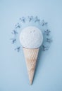 Composition of ice cream cone with bath ball on a blue background Royalty Free Stock Photo