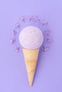 Composition of ice cream cone with bath ball on a violet background. Bathroom cosmetic accessories Royalty Free Stock Photo