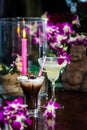 Still life with Iced coffee with cream, orchid flowers, burning Royalty Free Stock Photo