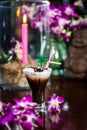 Still life with Iced coffee with cream orchid flowers burning ca Royalty Free Stock Photo