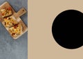 Composition of image with pizza on chopping board and copy space with black spot on beige background