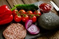 Composition of ingredients for beef black burger on a black stone board. Black burger Royalty Free Stock Photo