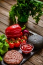 Composition of ingredients for beef black burger on a black stone board. Black burger Royalty Free Stock Photo