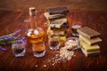 Composition of ingredients, lavender, oil and craft soap on wooden table. Handmade soap bars on wooden board Royalty Free Stock Photo