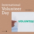 Composition of international volunteer day text and african american man in volunteer t-shirt