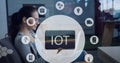 Composition of iot icon with network of connections over woman using laptop Royalty Free Stock Photo