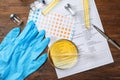 Composition with laboratory equipment and urine samples on wooden background. Urology concept