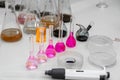 Composition of laboratory material with colored liquids in realistic glass pots