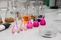 Composition of laboratory material with colored liquids in realistic glass pots