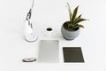 Composition with laptop, desklamp, plant and cup of coffee Royalty Free Stock Photo