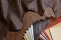 The composition of leather samples on a natural cow leather. Top view. Royalty Free Stock Photo