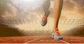 Composition of legs of running athlete on racing track in sports stadium Royalty Free Stock Photo