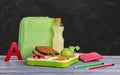 Composition with lunch box and food on grey wooden table near blackboard Royalty Free Stock Photo