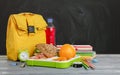 Composition with lunch box and food on wooden table near blackboard Royalty Free Stock Photo