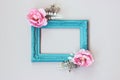 Composition made of decorative picture frame and pastel colored flowers; with copy space Royalty Free Stock Photo