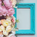 Composition made of decorative picture frame and pastel colored flowers; with copy space Royalty Free Stock Photo