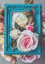 Composition made of photo frame and artificial flowers in pastel colors Royalty Free Stock Photo