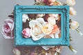 Composition made of photo frame and artificial flowers in pastel colors Royalty Free Stock Photo