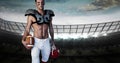 Composition of male american football player holding ball over sports stadium Royalty Free Stock Photo