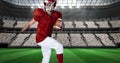 Composition of male american football player holding ball over sports stadium Royalty Free Stock Photo