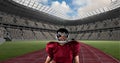 Composition of male american football player holding ball over sports stadium Royalty Free Stock Photo