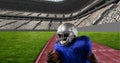 Composition of male american football player holding ball over sports stadium Royalty Free Stock Photo