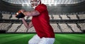 Composition of male american football player throwing ball over sports stadium Royalty Free Stock Photo