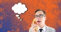Composition of man talking on retro phone, speech bubble with copy space on orange background Royalty Free Stock Photo