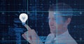 Composition of man touching virtual screen with light bulb icon and data processing Royalty Free Stock Photo