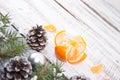 Composition with mandarins and Christmas tree on white rustic wooden background with copy space for text. Christmas mock-up or gr Royalty Free Stock Photo