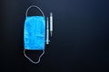 Composition of a medical equipment. Blue cotton surgical mask, plastic disposable 2 ml syringe and thermometer Royalty Free Stock Photo
