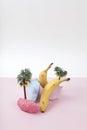 composition and metaphor for an island with palm trees, composed of ripe bananas and brightly painted pebbles Royalty Free Stock Photo