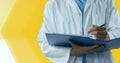 Composition of midsection of male doctor in lab coat writing holding file