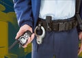 Composition of midsection of male security guard holding walkie talkie over office background Royalty Free Stock Photo