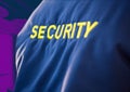 Composition of midsection of security guard blue jacket with yellow text over office background