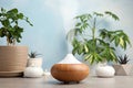 Composition with modern essential oil diffuser on table against blue background