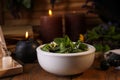 Composition with mortar, healing herbs and gemstones on table