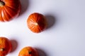 Composition of multiple orange pumpkins lying on white background